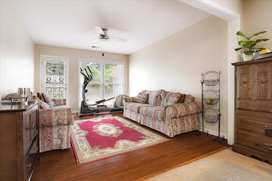 Living area featuring a ceiling fan and wood finished floors