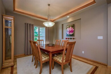 Formal dining room with lighted tray ceiling, hard