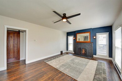 Living room features Brick Fireplace with remote c