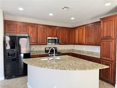 Kitchen with a sink, light stone countertops, stai