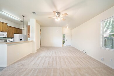 Spacious den open to kitchen & dining.