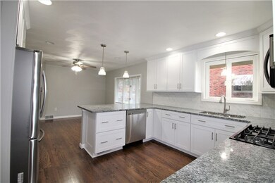 The kitchen is open to the dining room and these b