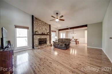 Freshly painted great room has Australian cypress hardwood flooring