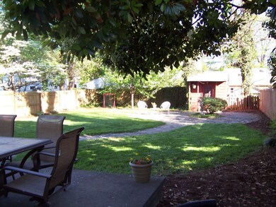 large fenced, level backyard w/shed