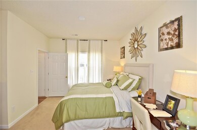 Bedroom featuring light colored carpet