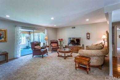 Formal living room features new carpet, recessed l