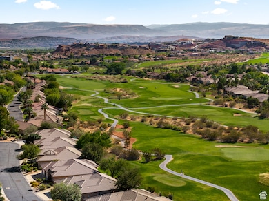 Aerial perspective of suburban area with a mountainous background and a golf course