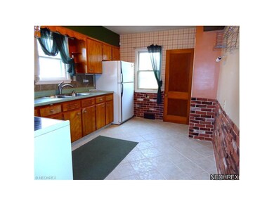 Kitchen w/ tile floors & backsplash.
