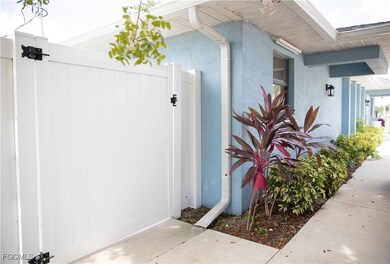 View of exterior entry with a gate and stucco siding