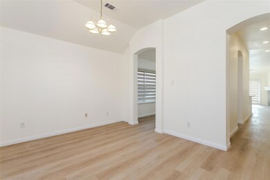 Spare room with lofted ceiling, a chandelier, and 