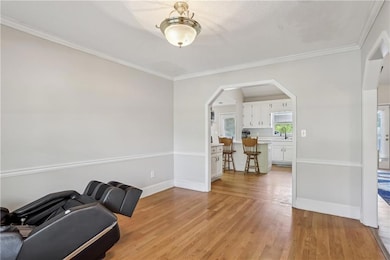 Living area featuring light wood-type flooring, ba