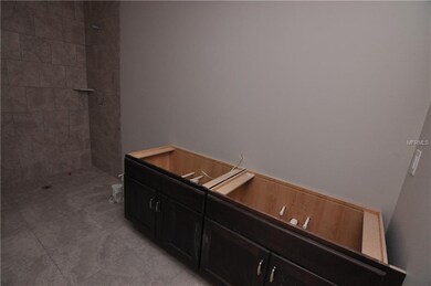 Master Bathroom featuring double sinks and a walk 