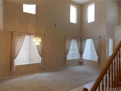 Formal living & dining with walls of windows to le