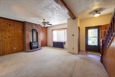 Large living room with a wood burning stove in a b