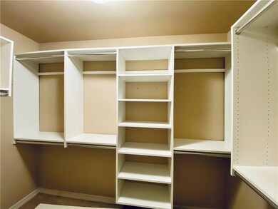 Walk in master closet with shelving