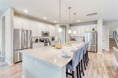 Kitchen with 2 refrigerators and two dish washers.