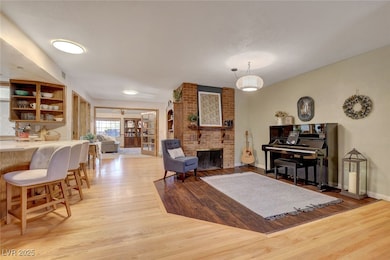 Living room featuring light wood-style floors, a b