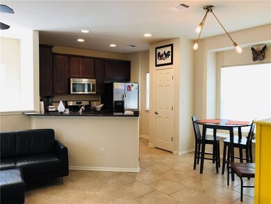 Kitchen with visible vents, dark brown cabinets, 