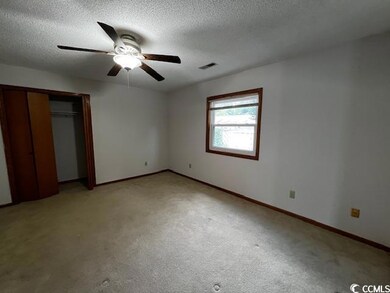 Unfurnished bedroom featuring a closet, carpet, ce