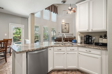 This charming two-story brick home features a well-maintained front yard with mature trees and landscaping. It has a double garage and a welcoming entrance, perfect for families seeking a comfortable and inviting residence.