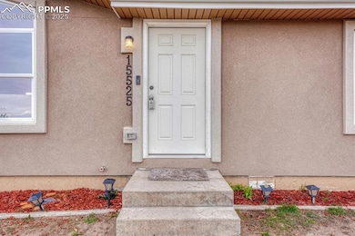 Entrance to property featuring stucco siding