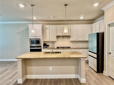 Kitchen featuring under cabinet range hood, backsp