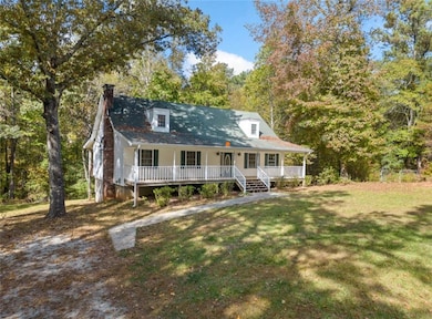 Cape cod house featuring covered porch and a front