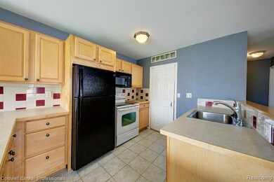 Roomy kitchen with maple cabinets.