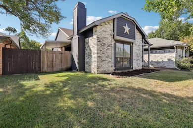 Back of property with a chimney and brick siding
