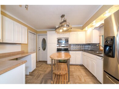 Bright kitchen with enamel cabinets, stainless app