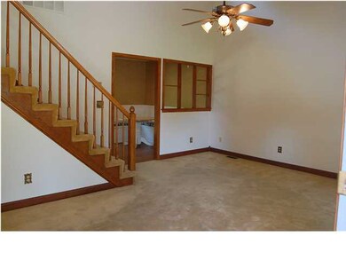 Stairs up to the bedrooms and downstairs to the fa