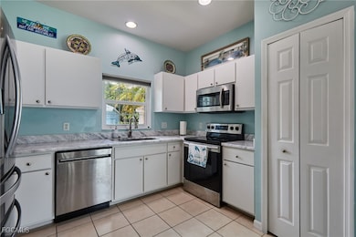 Kitchen with stainless steel appliances, light cou