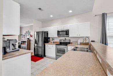 Kitchen featuring stainless steel appliances, ligh