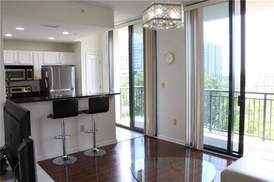 Kitchen featuring stainless steel appliances, dark countertops, wood finished floors, baseboards, and recessed lighting