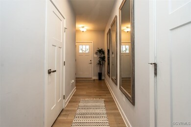 Entryway with light wood-style floors and baseboar