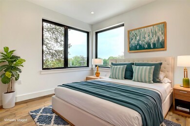 Bedroom featuring multiple windows, baseboards, w