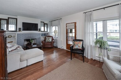 Living room featuring a brick fireplace and dark hardwood / wood-style flooring