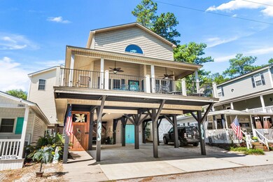 View of front of house featuring a ceiling fan, a carport, and driveway
