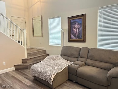 Living room featuring stairway, baseboards, and wo