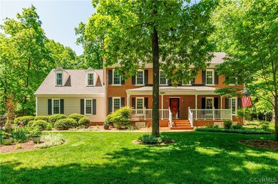 Colonial house with a porch and a front yard