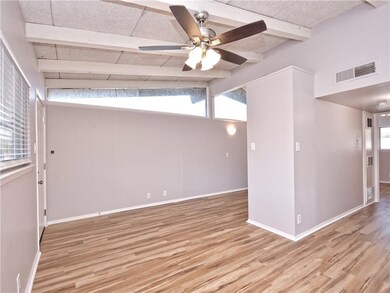 Unfurnished room with baseboards, visible vents, 