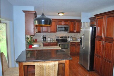 Kitchen offers tons of cabinets, granite counters,
