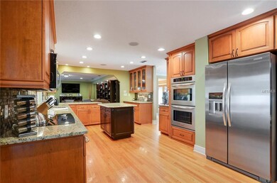 Large spacious kitchen with wood cabinetry, double