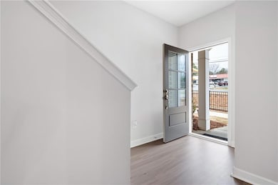 Foyer featuring wood finished floors and baseboards