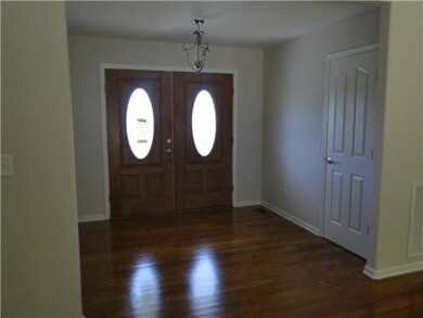 10x8 Entry foyer with hardwood flooring and coat closet