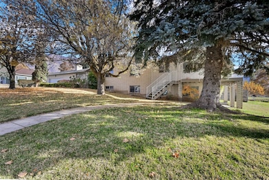 View of green lawn featuring stairs