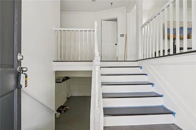 Staircase featuring ornamental molding