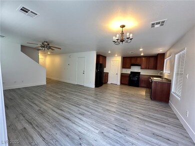 Kitchen featuring visible vents, black appliances,