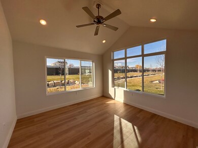 Spare room featuring wood finished floors, a ceiling fan, recessed lighting, high vaulted ceiling, and a residential view