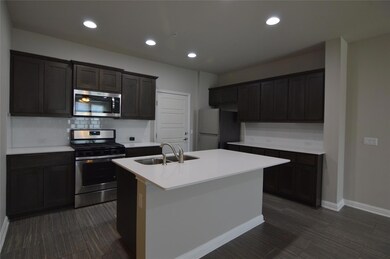 Kitchen featuring stainless steel appliances, a s